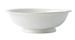 The Juliska Puro Whitewash Footed Fruit Bowl features a wide rim and short pedestal base—ideal for displaying fresh citrus on your countertop. Shown here in plain white ceramic against a white background.