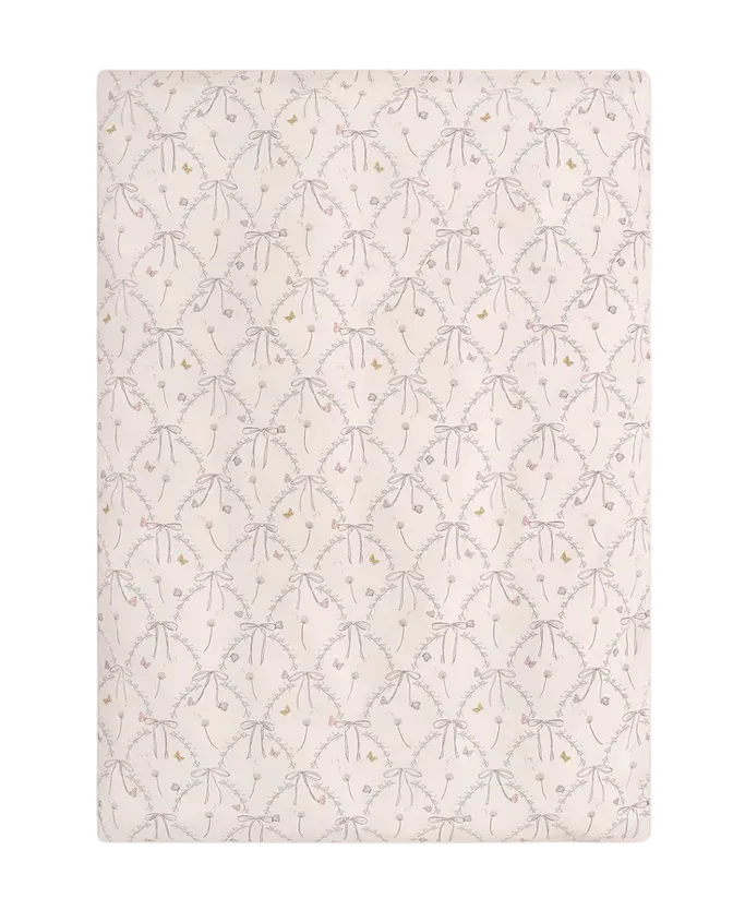 Experience the Bows & Butterfly Kisses Bedding Collection from Gooselings—rectangular bedding featuring a repeating pattern of light gray bows and delicate pastel flowers on a cream background, crafted from breathable, OEKO-TEX certified pure materials.