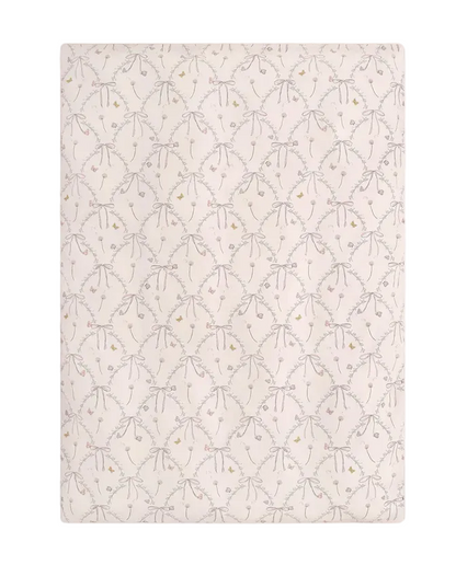 Experience the Bows & Butterfly Kisses Bedding Collection from Gooselings—rectangular bedding featuring a repeating pattern of light gray bows and delicate pastel flowers on a cream background, crafted from breathable, OEKO-TEX certified pure materials.