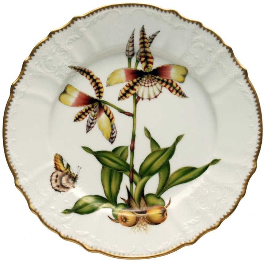 The Orchid IV Dinnerware Collection by Anna Weatherley showcases a porcelain dinner plate with a hand-painted orchid, green leaves, brown bulbs, a butterfly design, and is finished with a shimmering gold rim.