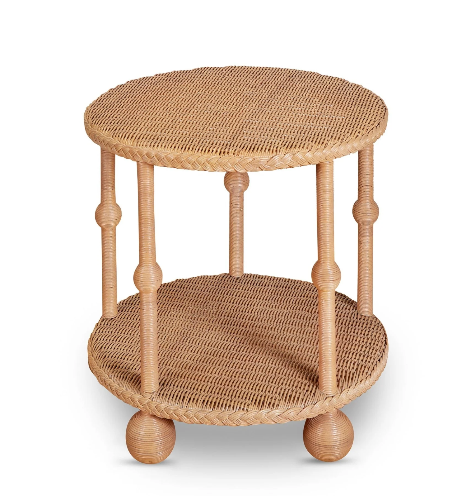 The Lucas Drinks Table by Bunny Williams features a spacious round wicker design with a woven top and lower shelf, four spindle legs, and round feet—perfect as a drinks table. Pictured here against a white background.