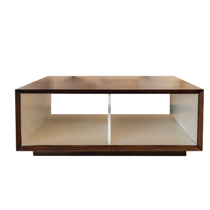 Minimalist in design, the Hadley Square Cocktail Table by Hickory Chair is a rectangular wooden coffee table crafted from solid walnut, featuring an open shelf divided into two compartments, set against a plain white background.