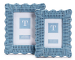 The Wicker Weave Scalloped Frame Collection in blue by Two's Company features two rustic, finely crafted rattan frames with scalloped edges, shown in different sizes against a white background.