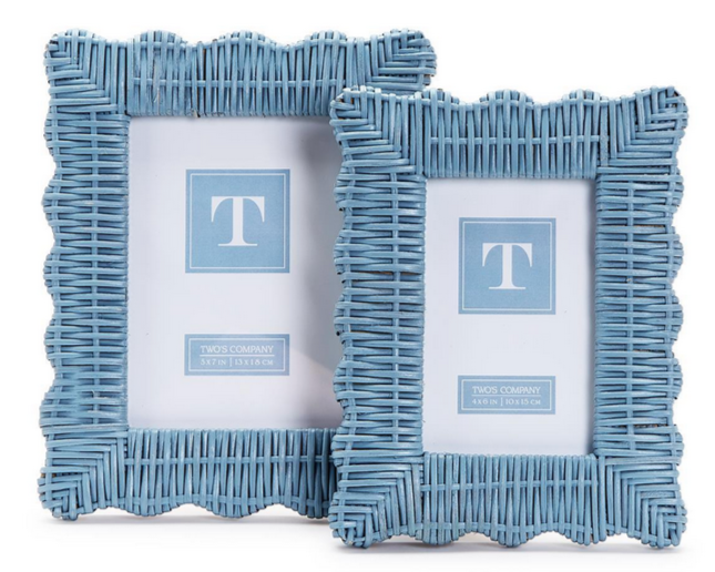 The Wicker Weave Scalloped Frame Collection in blue by Two's Company features two rustic, finely crafted rattan frames with scalloped edges, shown in different sizes against a white background.