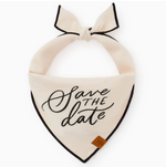 The Foggy Dog Save the Date Dog Bandana is a cream-colored bandana with black trim, tied at the top, and features "Save the date" script—an adorable personalized pet sign for your wedding announcement.