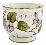 The Anna Weatherley Pansy Round Cachepot features white Hungarian porcelain with a gold rim, hand-painted with green leaves, purple flowers, and a blue butterfly in the brand’s elegant style.