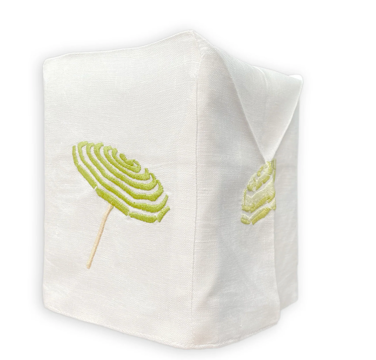 The Haute Home Beach Umbrella Bath Collection linen tissue box cover features green and yellow spiral lollipop embroidery on two sides, beautifully displayed against a white background.