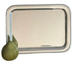 The Vintage Oblong Tray by Hôtel Silver, styled after European hotel silver, displays a green pear resting at its lower left corner.