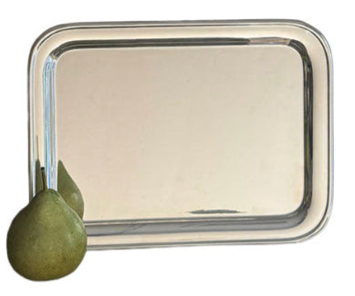 The Vintage Oblong Tray by Hôtel Silver, styled after European hotel silver, displays a green pear resting at its lower left corner.