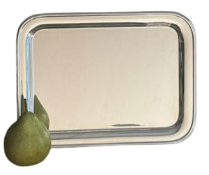 The Vintage Oblong Tray by Hôtel Silver, styled after European hotel silver, displays a green pear resting at its lower left corner.