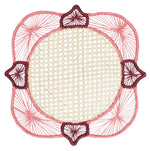 Experience the artistry of traditional Colombian craftsmanship with the Lily & Heliconia Placemat Collection by Mercedes Salazar. Each decorative round woven mat features a beige center, pink and burgundy thread accents, and a geometric border design. Skillfully handwoven from raffia, these stunning placemats showcase vibrant detail inspired by Mercedes Salazar’s signature style.