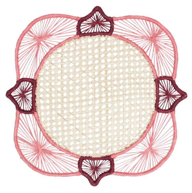 Experience the artistry of traditional Colombian craftsmanship with the Lily & Heliconia Placemat Collection by Mercedes Salazar. Each decorative round woven mat features a beige center, pink and burgundy thread accents, and a geometric border design. Skillfully handwoven from raffia, these stunning placemats showcase vibrant detail inspired by Mercedes Salazar’s signature style.