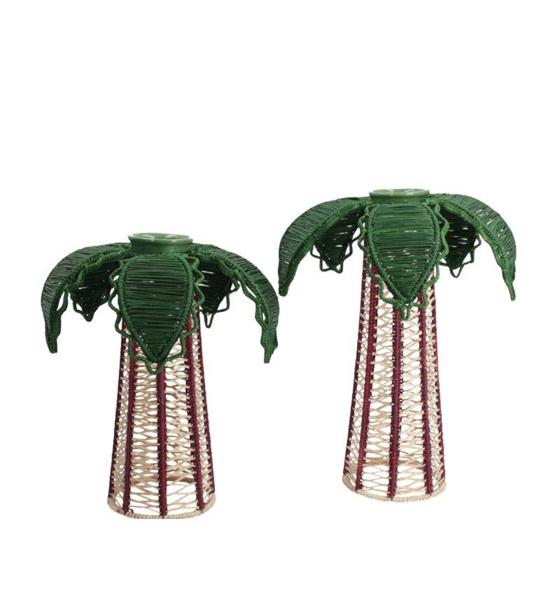 Introducing the Mercedes Salazar Palm Candle Holder & Flower Vase: two handcrafted pieces made from natural raffia fiber, each featuring tall conical bases topped with green, palm-inspired leaves. These unique decorative holders—displayed against a white background—are perfect for showcasing your favorite battery-powered candle or as charming flower vases.