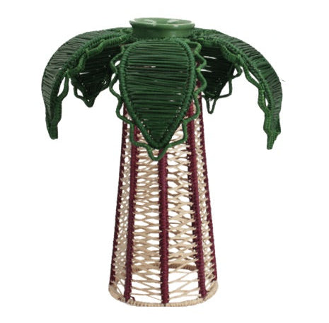 The Palm Candle Holder & Flower Vase by Mercedes Salazar is a handcrafted piece featuring a woven reed design with a conical base and green, leaf-like fronds reminiscent of a stylized palm tree, artfully adorned with raffia fiber for a natural, artisanal accent.