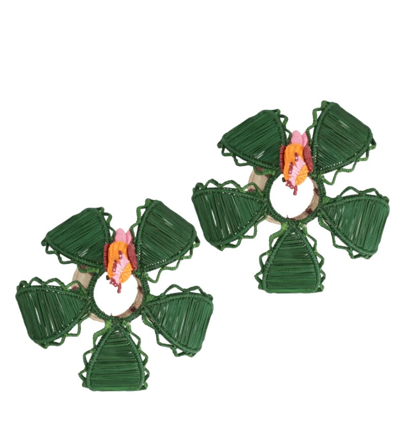 Elevate your table setting with the handcrafted Hoatzin Palm Candle Holder & Flower Vase by Mercedes Salazar—this set features two green woven pieces, each with five petal-like sections and vibrant pink and orange accents at the center, creating charming dining decor displayed elegantly on a white background.