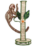 Introducing the Monkey Bloom Mico Flower Vase by Mercedes Salazar—a charming decorative piece shaped like a monkey climbing a tree, complete with green leaves and a small flower at the base. Beautifully crafted from natural raffia fiber, this handcrafted vase brings whimsical elegance and artistic flair to your dining decor, perfectly reflecting the distinctive style of Mercedes Salazar.