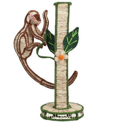 Introducing the Monkey Bloom Mico Flower Vase by Mercedes Salazar—a charming decorative piece shaped like a monkey climbing a tree, complete with green leaves and a small flower at the base. Beautifully crafted from natural raffia fiber, this handcrafted vase brings whimsical elegance and artistic flair to your dining decor, perfectly reflecting the distinctive style of Mercedes Salazar.
