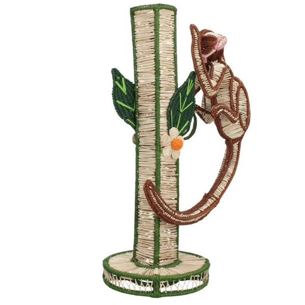 The Mercedes Salazar Monkey Bloom Mico Flower Vase is skillfully crafted with natural raffia fiber for an artisanal touch, featuring a design reminiscent of a tree with a brown monkey figure climbing the trunk and green leaf decorations—an elegant piece inspired by handcrafted dining decor.