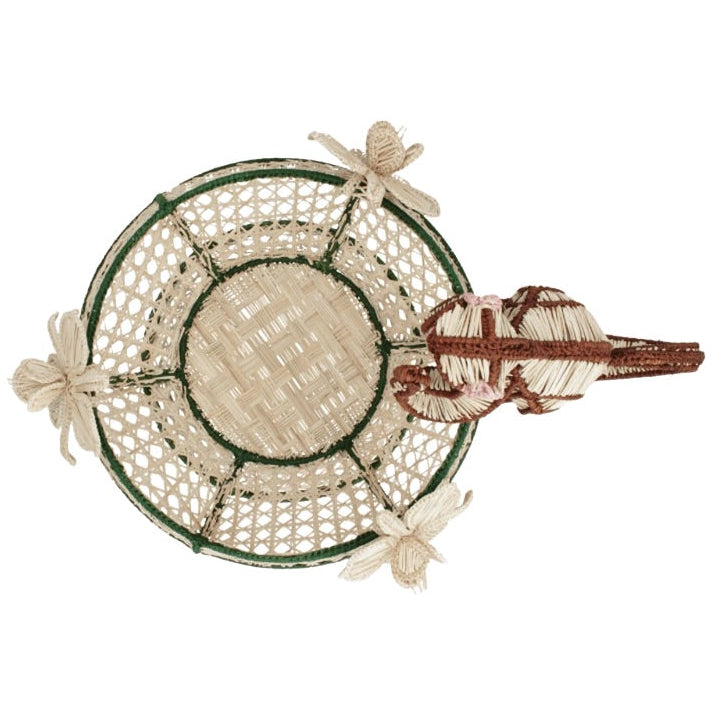Top view of the Forest Muse Mono Bowl by Mercedes Salazar, a handcrafted raffia basket with green trim, featuring three woven dragonflies and a woven lizard attached to its edge. This exquisite piece showcases the vibrant artistry of Bogotá, Colombia.