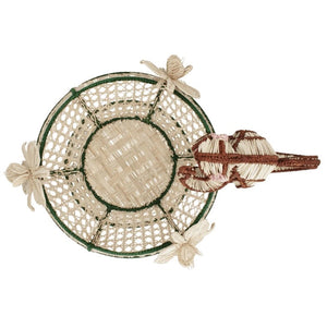 Top view of the Forest Muse Mono Bowl by Mercedes Salazar, a handcrafted raffia basket with green trim, featuring three woven dragonflies and a woven lizard attached to its edge. This exquisite piece showcases the vibrant artistry of Bogotá, Colombia.