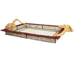 Mercedes Salazar's Monkey Jungle Party Tray is a rectangular, handwoven raffia tray featuring maroon edges, a netted base, and yellow rope handles at each corner—perfect for elevating your dining setting. Shown on a white background.