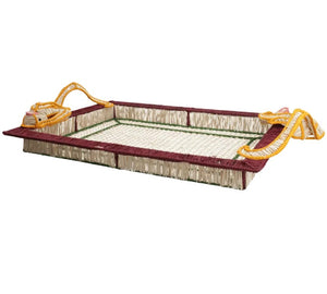 Mercedes Salazar's Monkey Jungle Party Tray is a rectangular, handwoven raffia tray featuring maroon edges, a netted base, and yellow rope handles at each corner—perfect for elevating your dining setting. Shown on a white background.