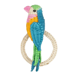 A vibrant woven parakeet figurine is affixed to a circular woven ring, creating the Parakeet Napkin Ring by Mercedes Salazar, displayed against a plain white background.