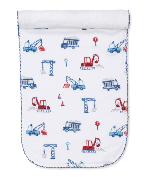 A Kissy Kissy Building Site Burp Cloth with construction vehicles on it, made from absorbent Pima cotton.