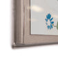 Close-up of Soicher Marin's "Habitat Naturelle 2 by Paule Marrot," featuring a visible blue flower detail in the corner reminiscent of Marrot’s signature style. The artwork is set in a frame with transparent edges and a fabric-textured mat, giving this digitally re-mastered print an elegant, contemporary twist.