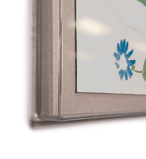 Close-up of Soicher Marin's "Habitat Naturelle 2 by Paule Marrot," featuring a visible blue flower detail in the corner reminiscent of Marrot’s signature style. The artwork is set in a frame with transparent edges and a fabric-textured mat, giving this digitally re-mastered print an elegant, contemporary twist.