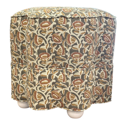 The Stella Stool by Bunny Williams features a square shape, earthy floral-patterned fabric cover, and four round wooden feet—ideal as an upholstered stool or cozy footrest.