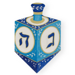Caspari Dreidel Luncheon Napkins feature blue dreidels with white panels, gold and blue designs, and Hebrew letters, all printed with non-toxic inks for safe holiday celebrations.