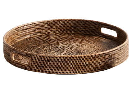 The Napa Home & Garden Burma Rattan Ottoman Tray from the Napa Home Burma Rattan Round Ottoman Tray Collection enhances home decor with its round wicker design and two side cut-out handles for convenience.