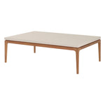 The Sloop Rectangle Cocktail Table by McGuire Furniture features a Bianco Crema Dune top and natural teak frame with four tapered legs—ideal for coastal spaces seeking relaxed charm and natural materials.