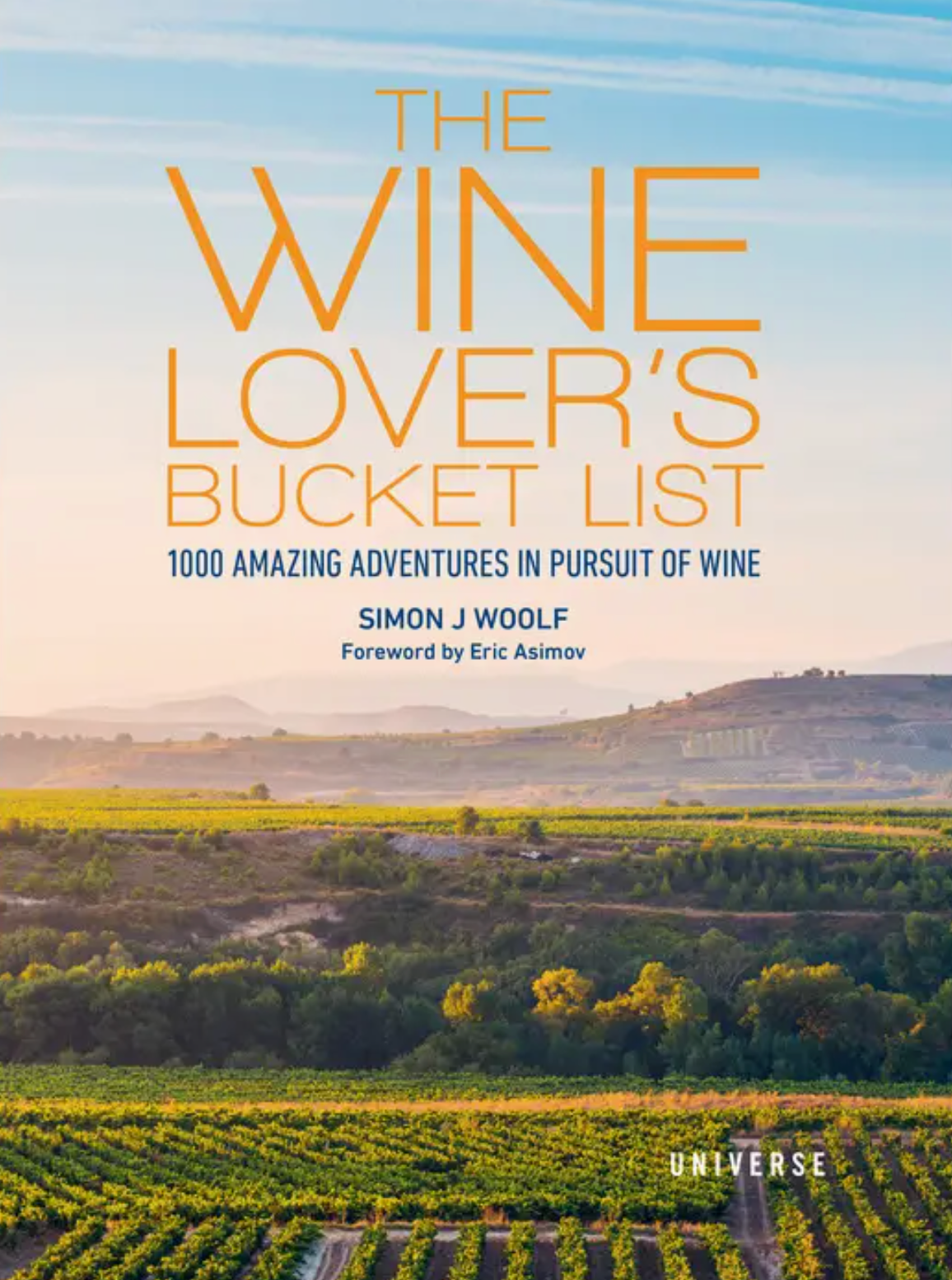 Book cover for The Wine Lover’s Bucket List from Rizzoli, displaying a picturesque vineyard landscape beneath a blue sky with rolling hills in the distance, evoking the excitement of wine adventures and inspiring journeys through vineyards.