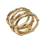 The Kim Seybert Gold Bamboo Napkin Ring features intertwined bamboo shapes and a textured, elegant gold-plated finish.