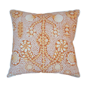 The Burnt Sienna Shell Grotto Outdoor Pillow by Associated Design features an intricate orange and white floral and circular pattern, crafted from premium materials for stylish outdoor décor.