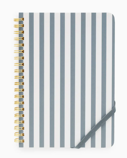 The Sugar Paper Mini Spiral Notebook showcases vertical gray and white stripes, elegant gold coil binding, and is secured with a gray elastic band at the bottom right corner. With lined pages inside, it’s perfect for jotting down your daily to-do lists.