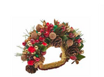 Kim Seybert Tinsel Bow Napkin Ring decorated with pinecones, red berries, and metallic holiday ornaments for Christmas table decor.
