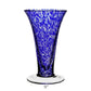 The Vanessa Vase Collection by William Yeoward Crystal showcases handmade blue and white speckled glass with a flared rim and clear base, evoking Mediterranean charm. Stands 9 inches tall.