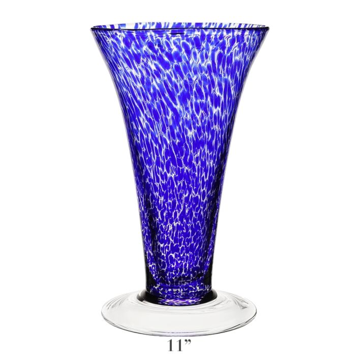 The Vanessa Vase Collection by William Yeoward Crystal features a tall, flared handmade crystal vase in Mediterranean blue with white speckles, clear round base, and 11-inch height.