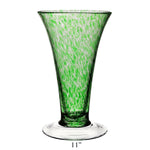 The Vanessa Vase Collection by William Yeoward Crystal features a handmade 11-inch crystal vase with a flared rim, green and white Mediterranean speckled pattern, and clear round base.