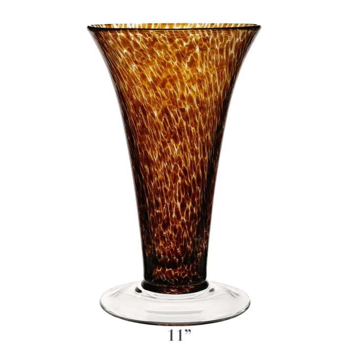 The Vanessa Vase Collection by William Yeoward Crystal features handmade crystal vases with flared rims, mottled amber Mediterranean hues, and clear round bases. Each vase stands 11 inches tall.