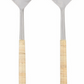 Two elegant serving utensils—the Aquila Serving Collection by Be Home—feature hammered metal bowls and light, textured handles. Handcrafted in India, the set includes an upright spoon and fork displayed side by side.