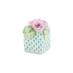 Herend’s "Roses in Vase" is a small, durable porcelain box featuring a green and white patterned base, hand-painted pink roses, and green leaves.
