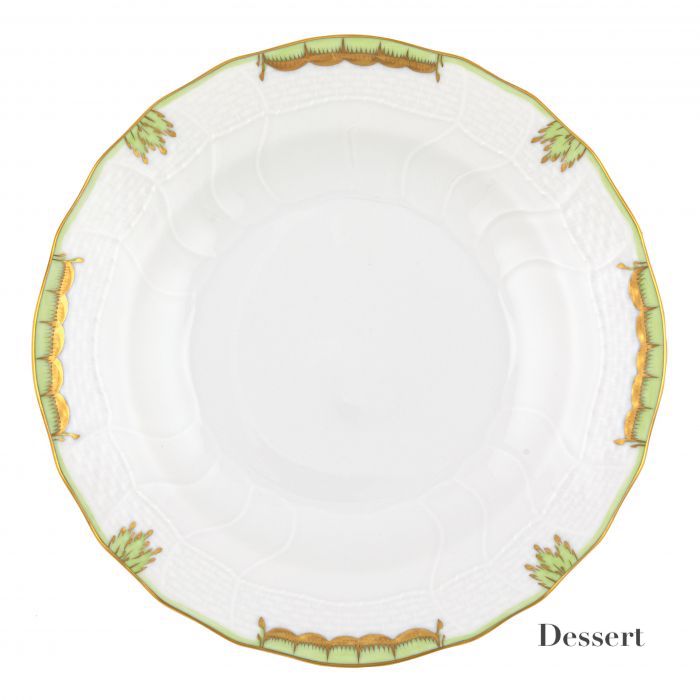 The Herend Princess Victoria Green Collection features a round white porcelain plate with a scalloped edge, hand-painted green and gold ornamental border, and "Dessert" in black—an homage to Queen Victoria’s elegant style.