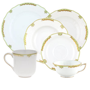 Herend's Princess Victoria Green Collection offers a set of white porcelain tableware adorned with green and gold accents, featuring hand-painted designs inspired by Queen Victoria. Includes two plates, a saucer, a teacup, and a mug.