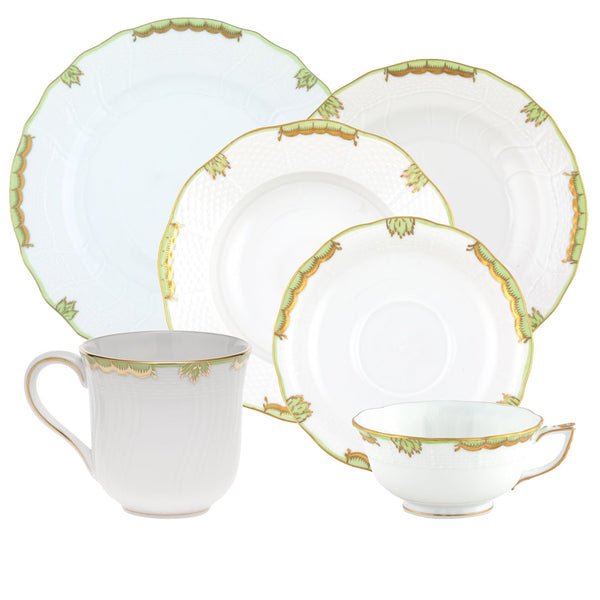 Herend's Princess Victoria Green Collection offers a set of white porcelain tableware adorned with green and gold accents, featuring hand-painted designs inspired by Queen Victoria. Includes two plates, a saucer, a teacup, and a mug.