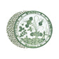 Set of two round Beatriz Ball Vida Faenza Melamine Placemats—one with a green botanical design, the other with a green and white leopard print—both inspired by classic Italian Faenza dinnerware.
