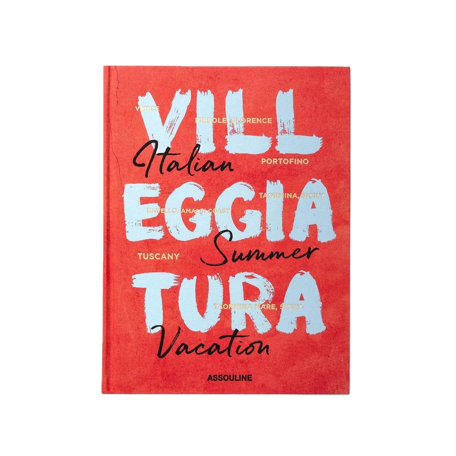 The red "Villeggiatura: Italian Summer Vacation" book by Assouline celebrates the allure of Italian luxury travel, with a cover featuring handwritten white and black text of Italian location names.